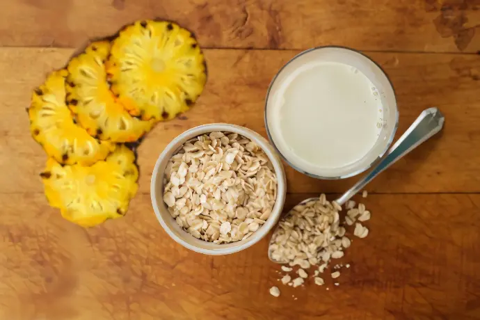 white ceramic bowl with white liquid beside yellow flower